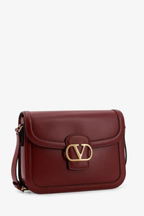 Valentino women’s leather shoulder bag in rich burgundy with gold-tone vlogo clasp and adjustable crossbody strap