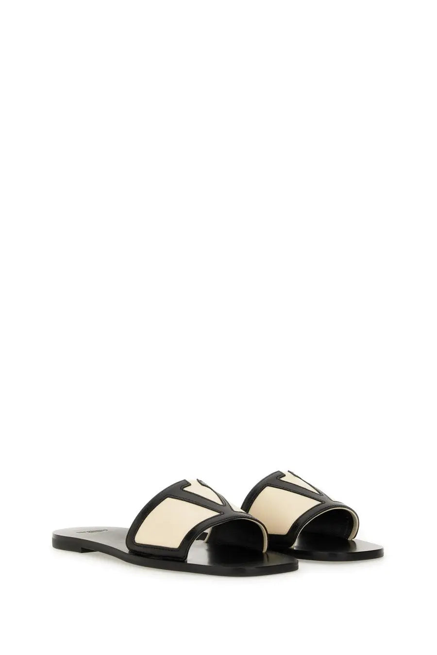 Valentino women’s viva superstar slide sandal in black and cream leather with bold geometric v-shaped strap design