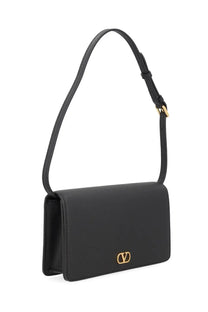 Black leather Valentino women’s Vlogo signature mini crossbody bag with gold-tone logo clasp