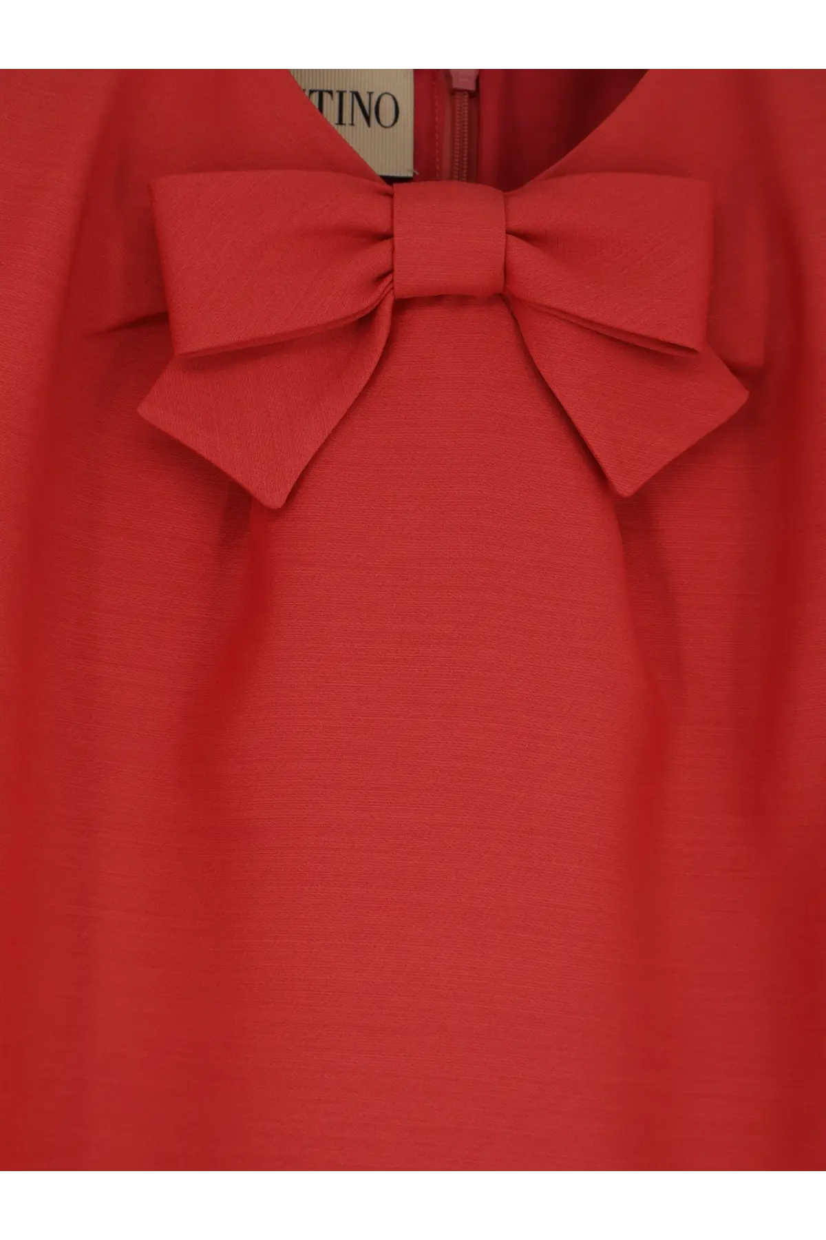 A vibrant red valentino women’s wool and silk blend short dress with a prominent bow at the neckline