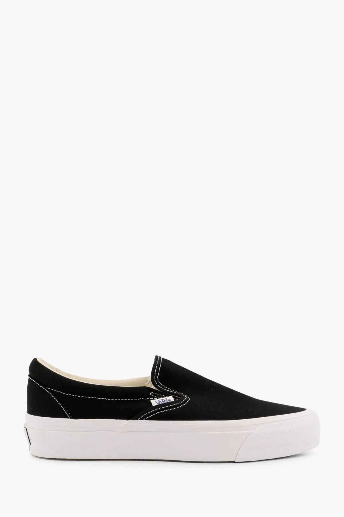 Vans men’s lx slip on reissue black canvas sneaker with white rubber sole and Vans logo on the side