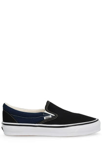 Vans men’s sneaker black canvas slip-on with navy blue suede panel white rubber sole classic Vans logo on side
