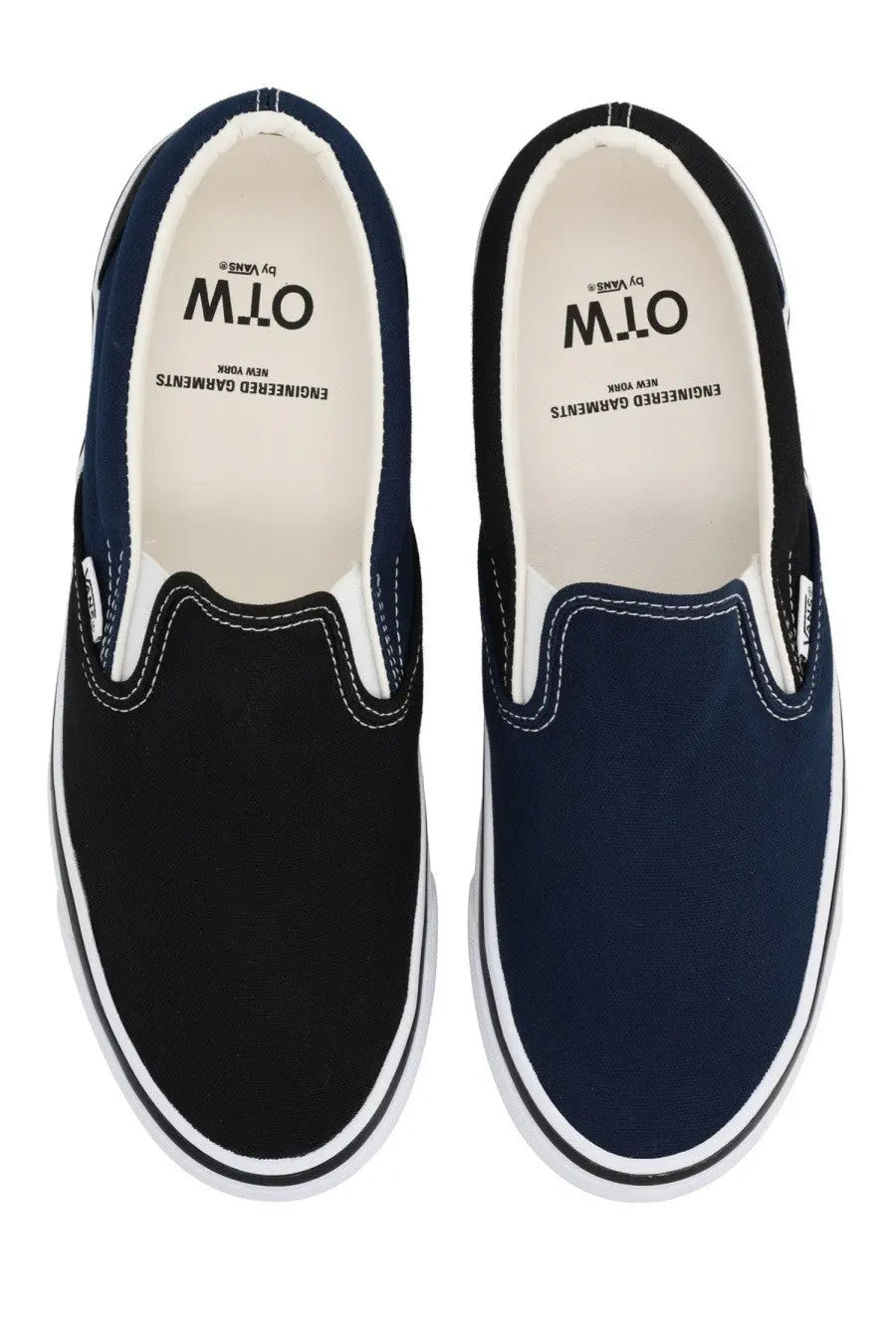 A pair of Vans men’s slip-on navy and black canvas sneakers with white rubber soles and contrasting stitching