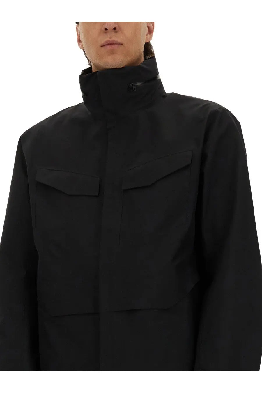 Veilance men’s black high-collar jacket with two chest pockets and a sleek modern design
