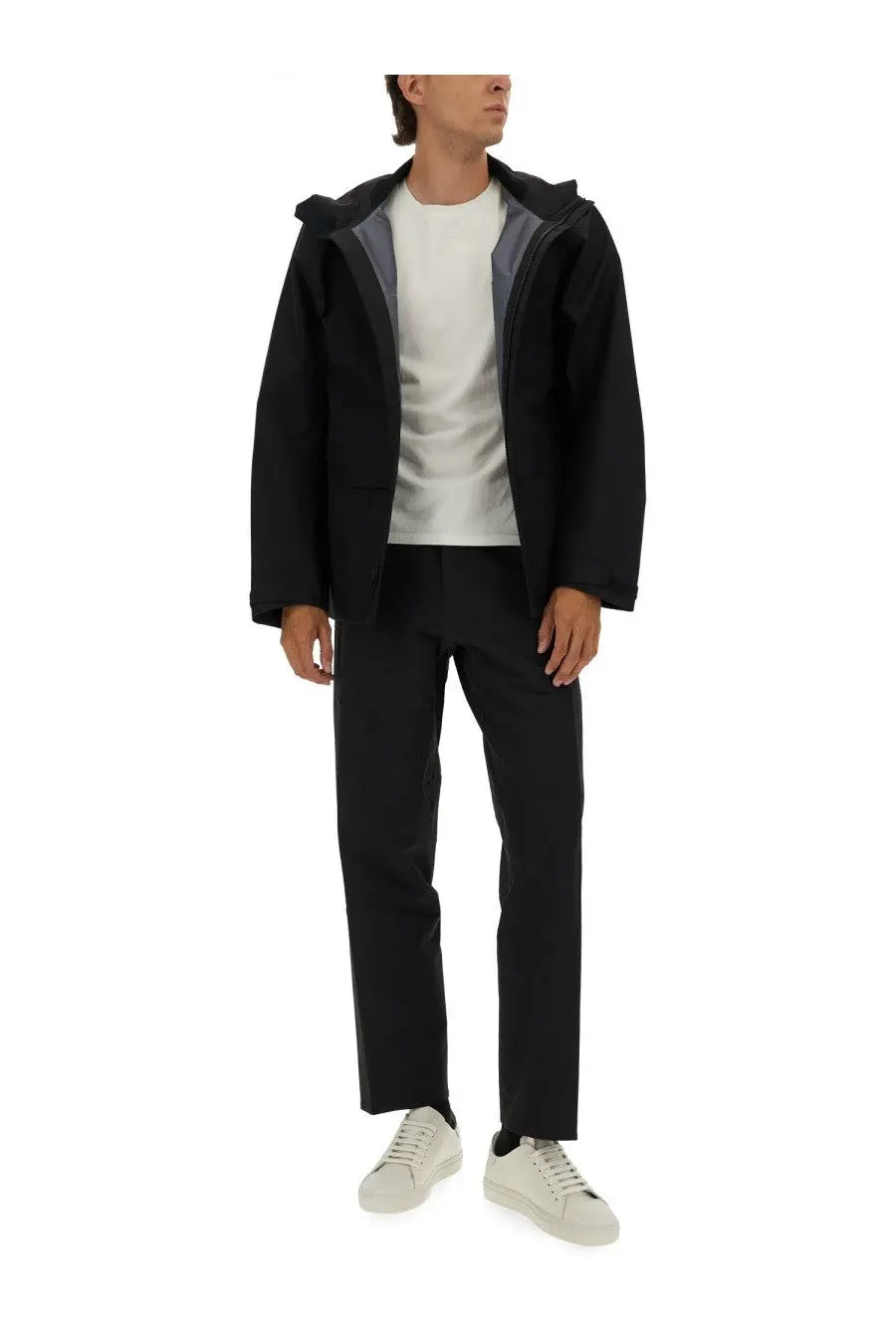 Veilance men’s black hooded jacket with subtle gray inner lining and sleek modern design in lightweight fabric