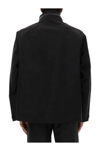 Veilance men’s black utility jacket with sleek minimalist design and subtle tonal contrast along collar