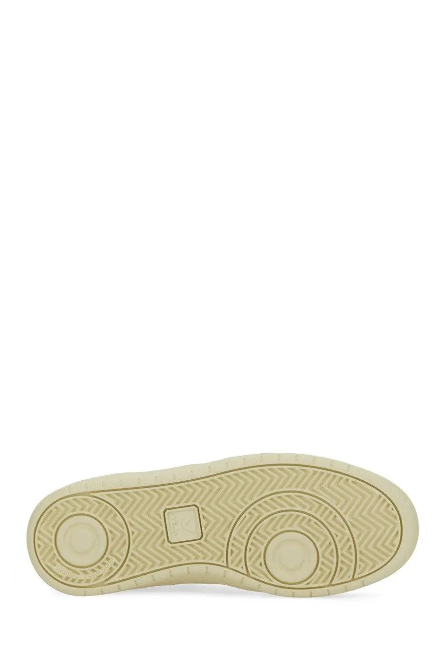Beige rubber sole with herringbone tread and circular design on veja women’s sneaker white bottom view