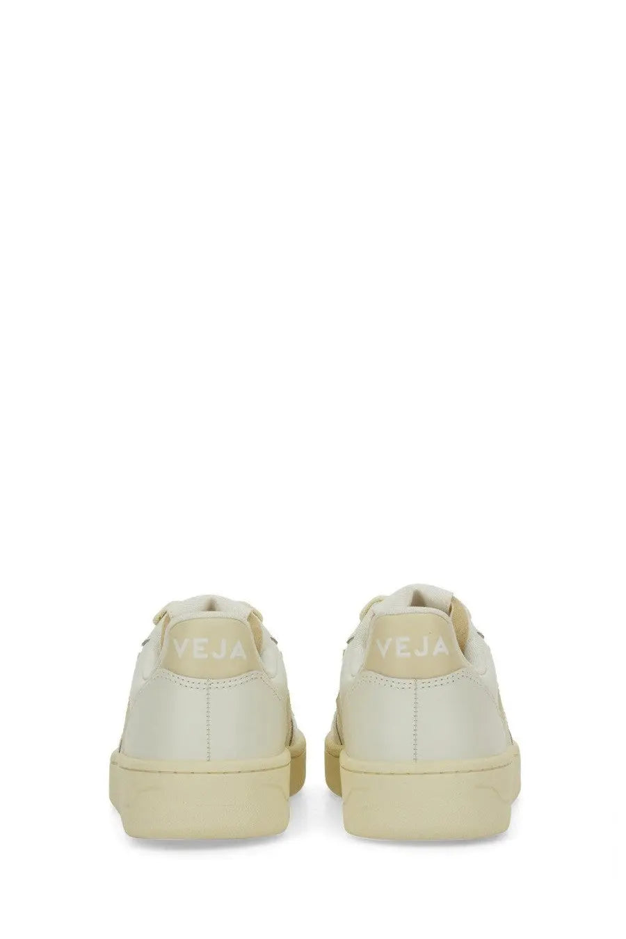 Back view of cream-colored vegan leather veja women’s sneaker with minimalist design and embossed brand name on heel