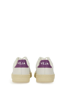 Veja women’s sneaker white leather with purple heel tab featuring veja logo and cream rubber soles shown from back