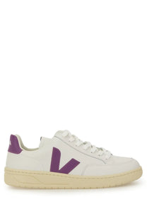 Veja women’s sneaker white featuring white leather with a bold purple V logo and matching purple heel tab