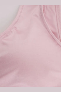 A soft pink nylon bikini top with smooth texture and neatly stitched edges from Venuja women’s collection