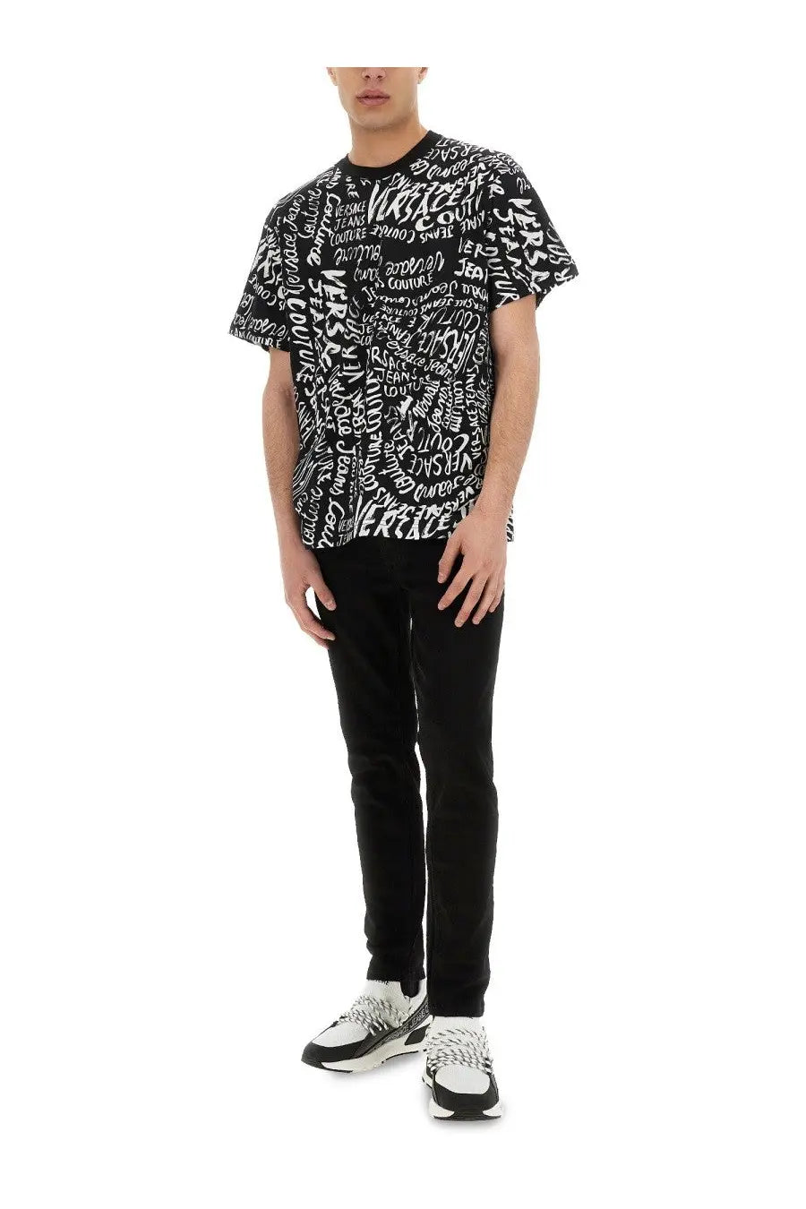 Black short-sleeved cotton t-shirt with bold white graffiti-style versace logomania print on the front by Versace Jeans Couture