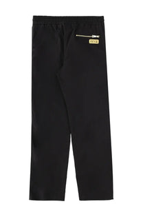 Back side of black versace jeans couture men’s pantalone jogger with gold zipper and brand patch on back pocket