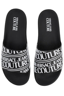 Versace Jeans Couture men’s black slide sandals with bold white repeating logo bands on the straps
