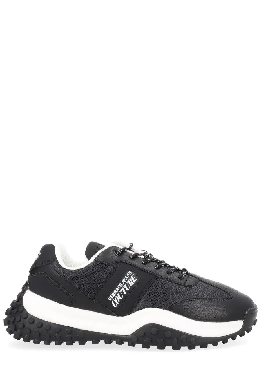 Versace jeans couture men’s sneaker in black with textured upper, white midsole, and chunky black rubber outsole