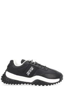Versace jeans couture men’s sneaker in black with textured upper, white midsole, and chunky black rubber outsole
