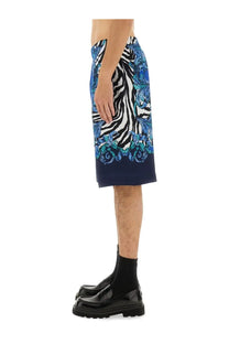 Versace Jeans Couture men’s viscose shorts in blue featuring vibrant blue and white zebra print with teal floral details and navy hemline