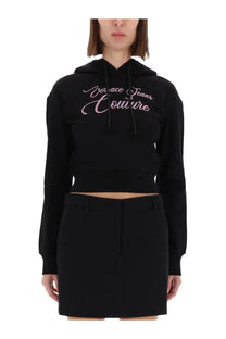 Versace Jeans Couture women’s black cropped hoodie with pink embroidered logo across the chest in cotton blend