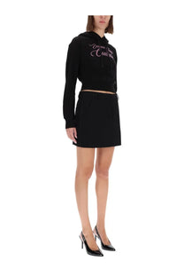 Versace jeans couture women’s black cropped sweatshirt with pink cursive lettering across the chest