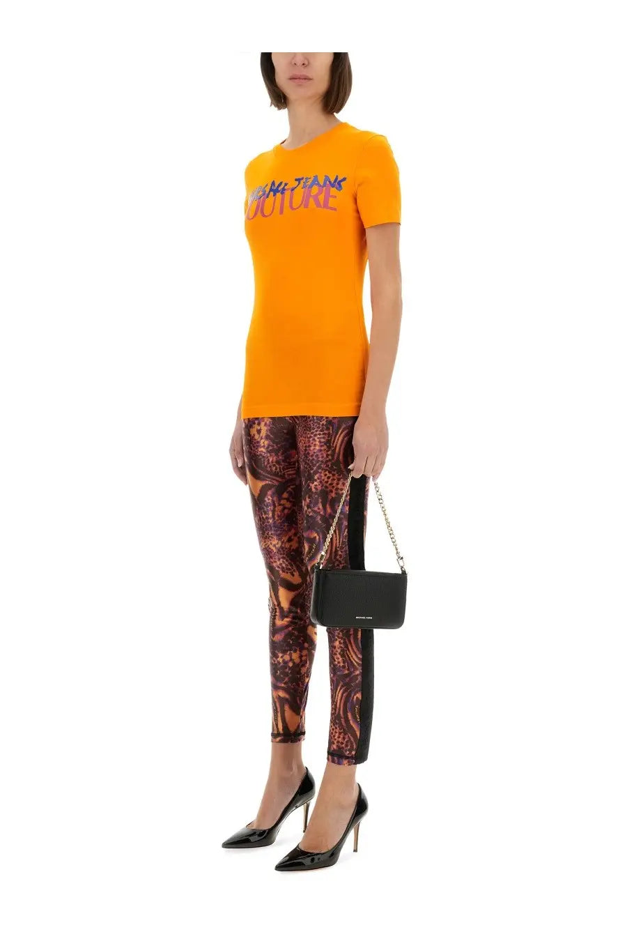 Black chain-strap handbag with sleek rectangular body paired with Versace Jeans Couture women’s orange shirt