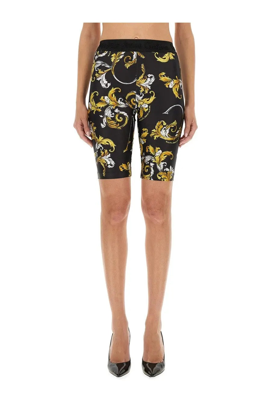 Versace jeans couture women’s black bike shorts with bold gold and white ornate baroque pattern on front side