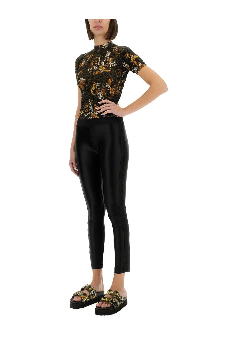 Versace jeans couture women’s black outline baroque knitted shirt paired with black glossy patent leather leggings