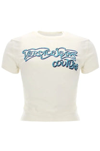 Cream-colored cropped t-shirt with sparkling blue sequined Versace Jeans Couture logo on chest for women