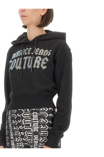 Versace Jeans Couture women’s black cropped hoodie with bold silver logo and matching patterned knit waistband