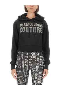 Versace Jeans Couture women’s black cropped hoodie with silver glitter logo lettering across the chest