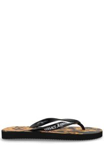 Versace Jeans Couture women’s black thong sandal with golden-brown Medusa head sole pattern and white logo strap