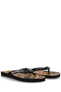 Versace jeans couture women’s black thong sandal with gold and black ornate patterned sole and white logo lettering