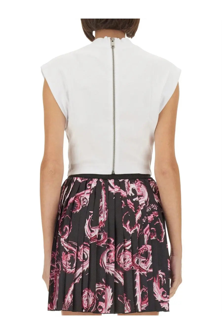 Versace Jeans Couture women’s white sleeveless top with silver back zipper paired with black pleated skirt with pink patterns