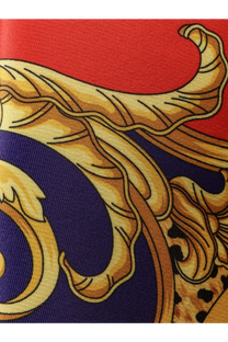 A luxurious red and navy silk scarf with an ornate gold-toned baroque design by Versace