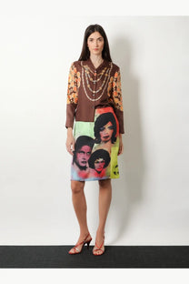 Versace women’s printed silk twill midi skirt gold with a brown silk blouse featuring vibrant orange and gold floral sleeves