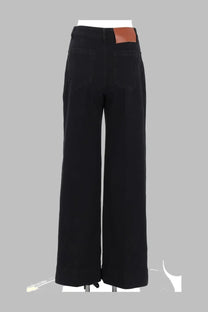 Black wide-leg denim trousers with a brown leather patch at the waistband from victoria beckham women s jeans alina black