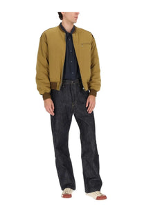 Visvim men’s gunner down jacket in olive green with dark brown ribbed cuffs and collar for cold weather wear