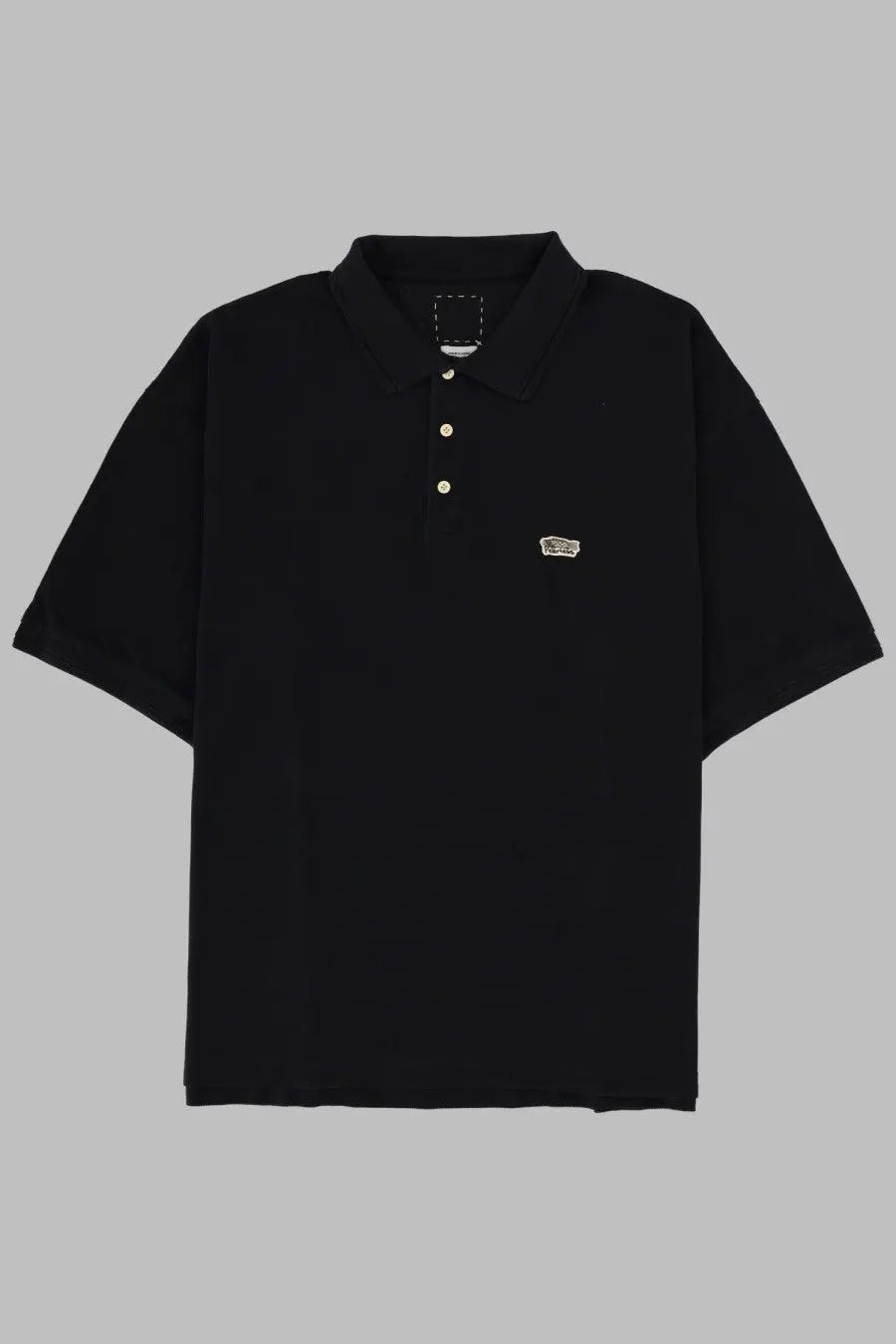Visvim men’s black short-sleeved polo shirt with white buttons and small embroidered vans logo on left chest