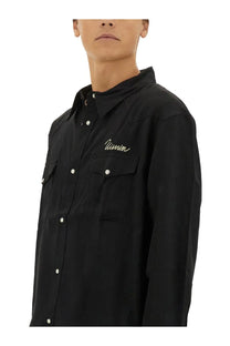 Visvim men’s black button-up shirt with white buttons and gold embroidered visvim logo on the chest