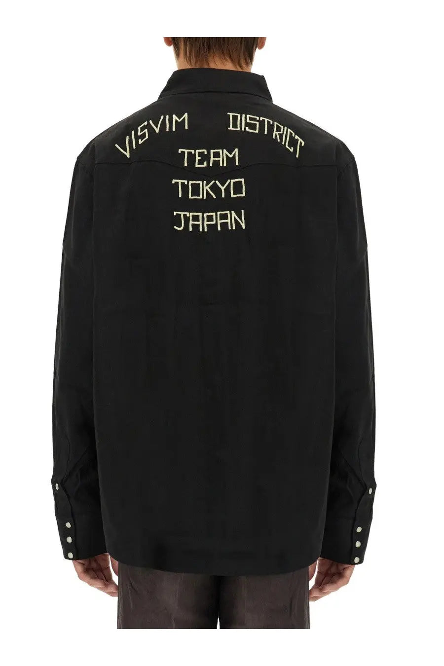 Visvim men’s black shirt showing the back side with cream embroidered visvim district team tokyo japan text