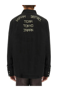 Visvim men’s black shirt showing the back side with cream embroidered visvim district team tokyo japan text