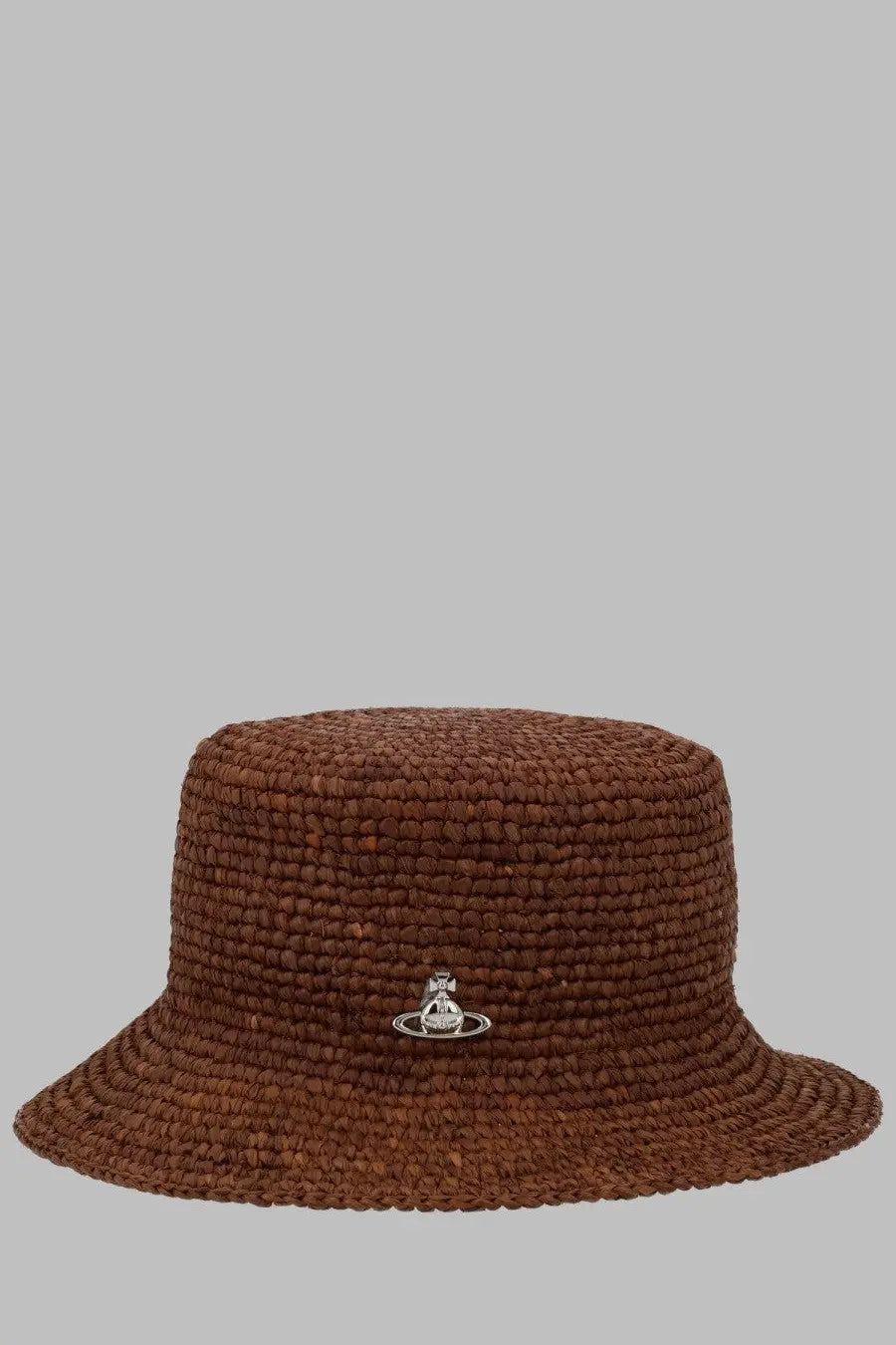Vivienne Westwood women’s brown woven straw bucket hat featuring a silver orb logo pin visible on the front