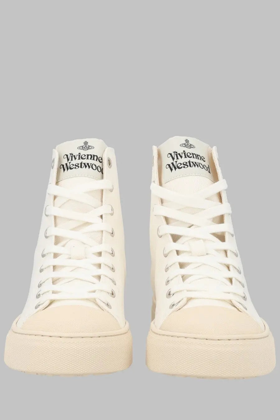 Cream-colored high-top canvas sneakers with white laces and vivienne westwood logo on the tongue