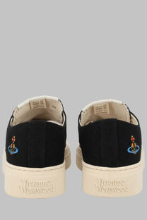 Back view of vivienne westwood women’s low top plimsoll sneaker in black canvas with cream rubber sole and embroidered logo