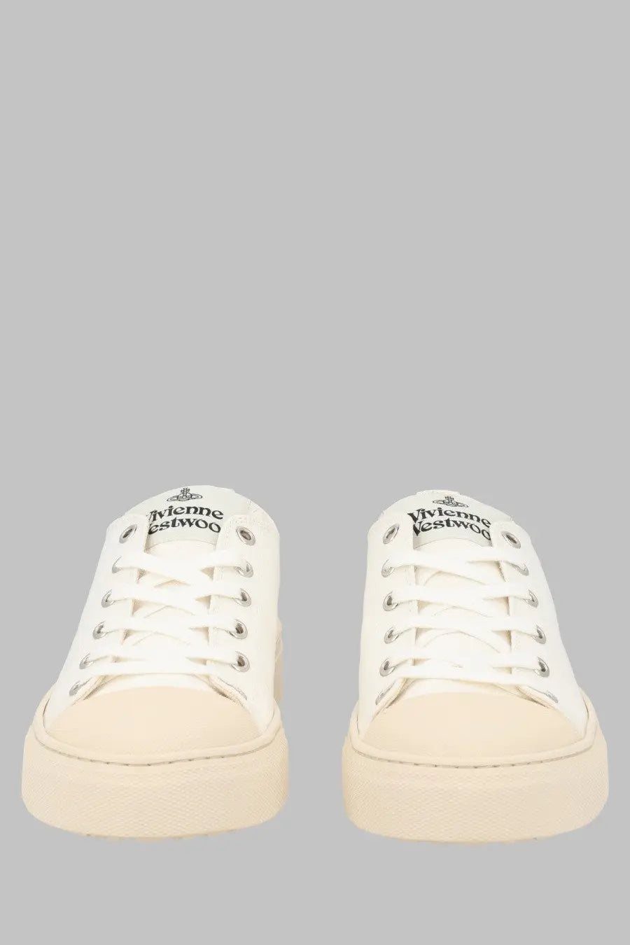 Vivienne Westwood women’s low top canvas sneakers in white with silver eyelets and cream rubber sole featuring logo tongue