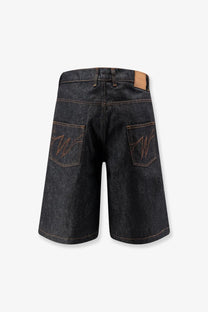 Back side of dark-wash Walk In Paris men’s baggy raw denim shorts with embroidered w logos on each pocket