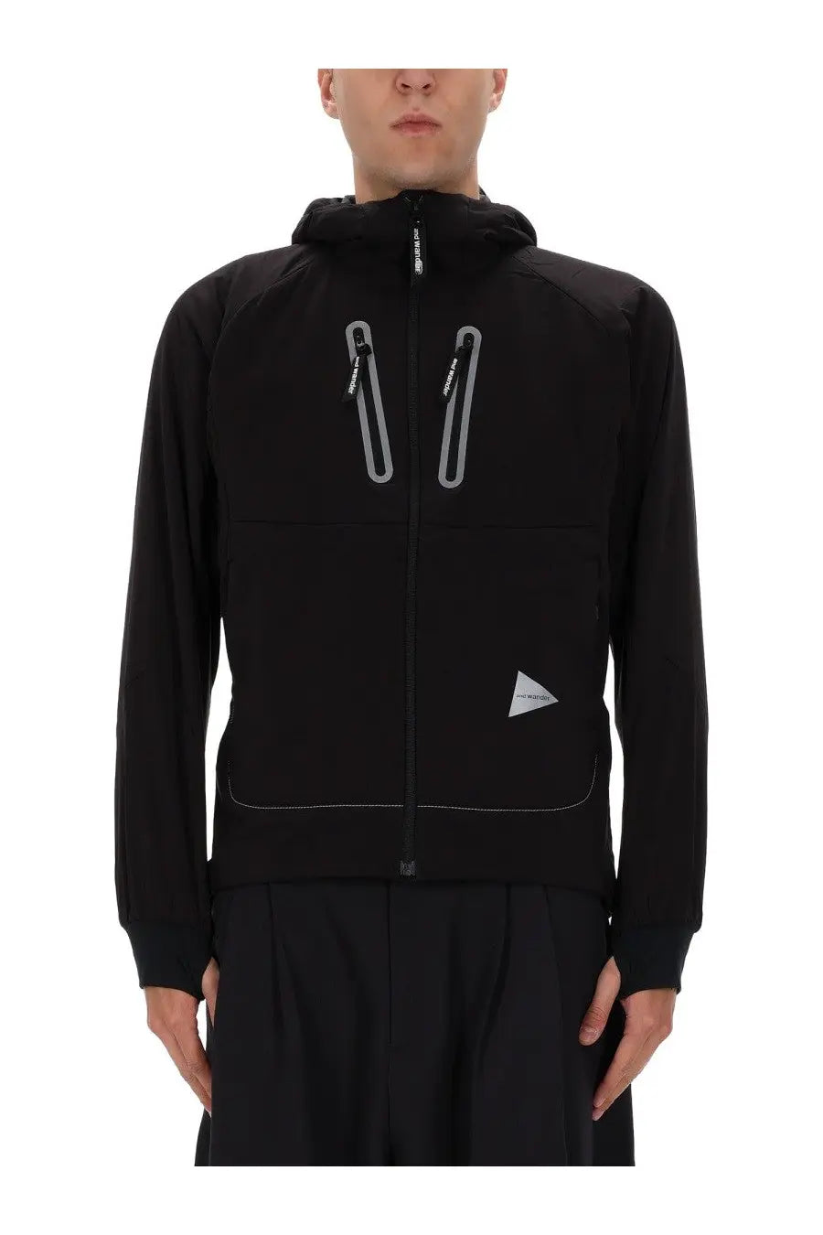 Black hooded jacket with reflective silver zippers and a triangular logo patch by and wander men’s alpha air jacket black