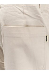 Beige cotton canvas pocket with woven brand tag on woodbird men’s denim trousers white back side