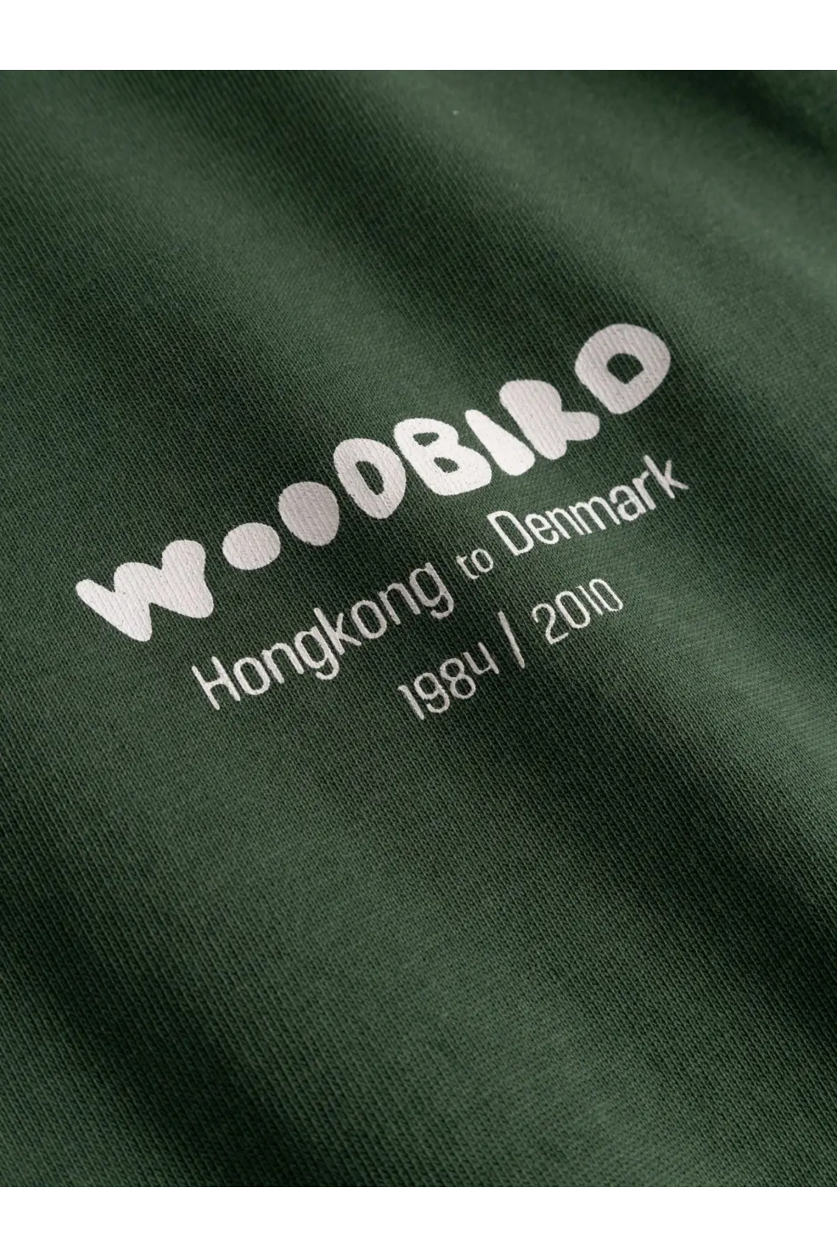 Dark green woodbird men’s wbbaine organic cotton t-shirt with white logo and hongkong to denmark 1984 2010 print