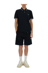 Black short-sleeved polo shirt with white trim and embroidered logo paired with woolrich men’s belted bermuda shorts blue