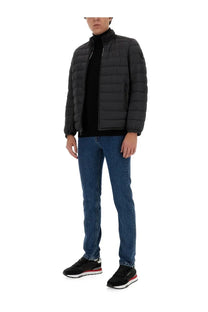 Woolrich men’s black quilted puffer jacket with high collar and front zipper made from warm insulated material